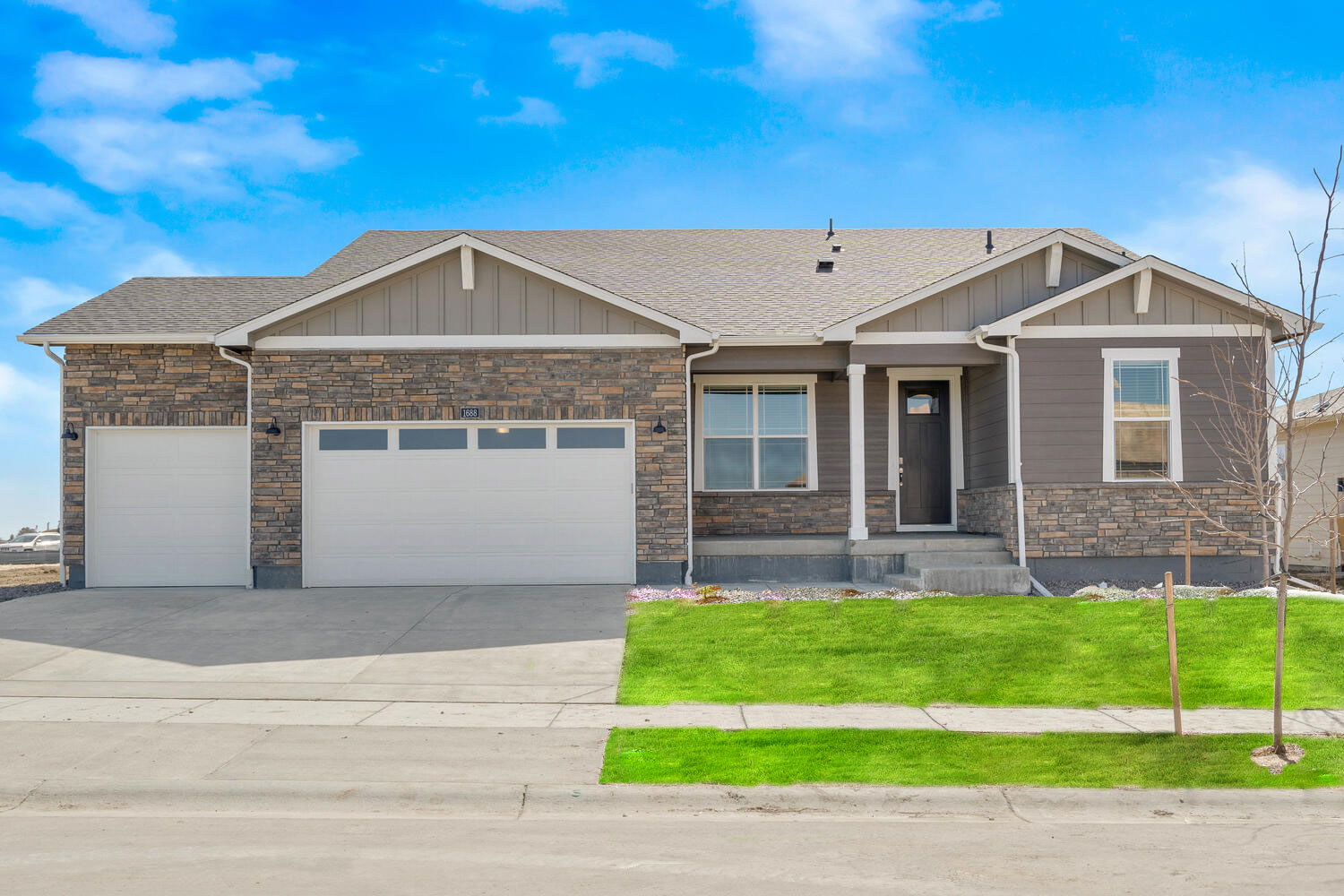 grover floorplan exterior photo with three car garage and front yard landscaping