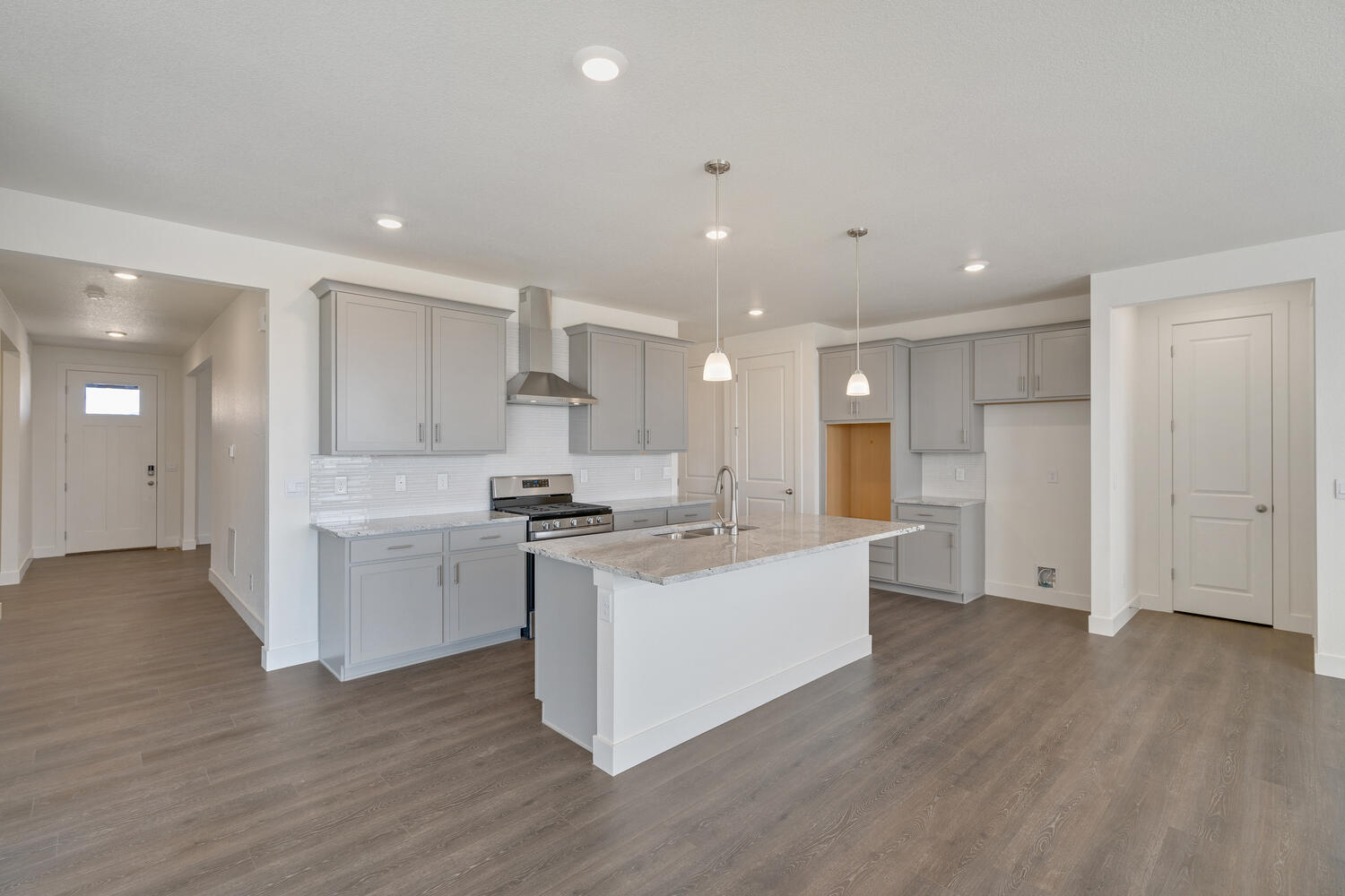 gray cabinet kitchen with an island and stainless steel appliances