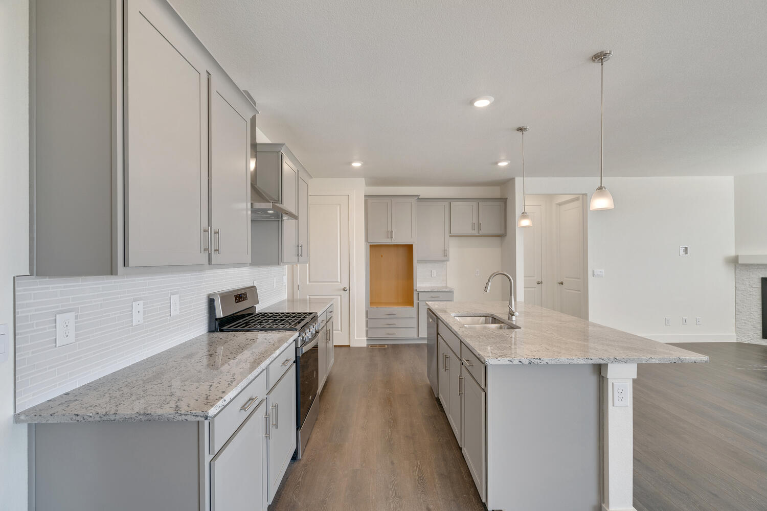 gray cabinet kitchen with an island and stainless steel appliances
