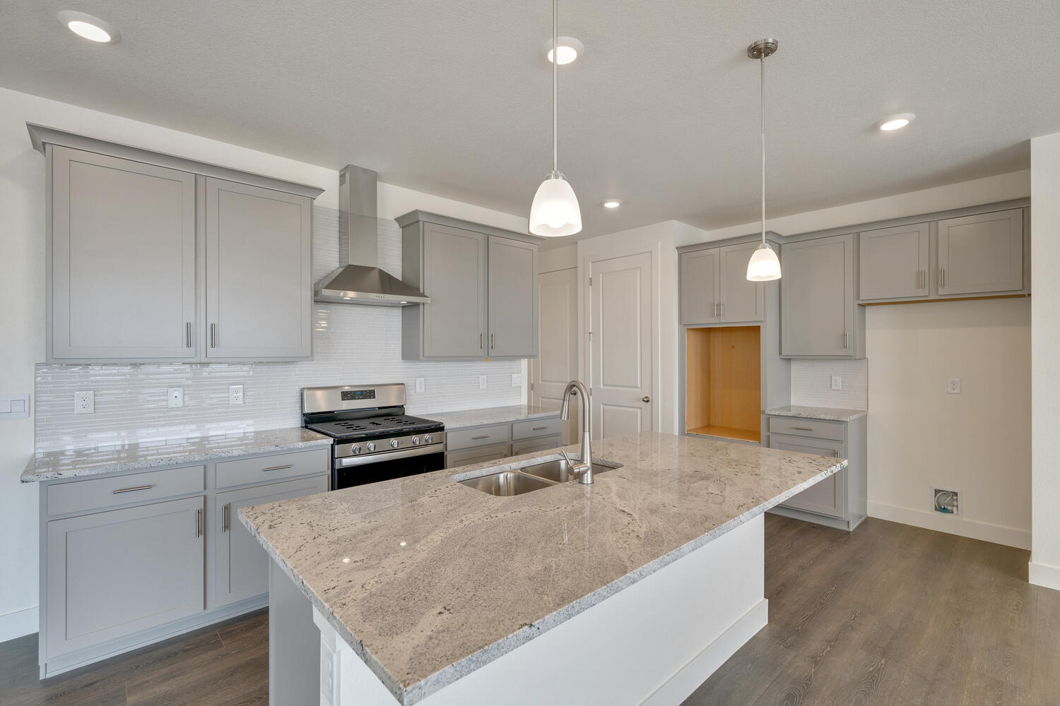 gray cabinet kitchen with an island and stainless steel appliances