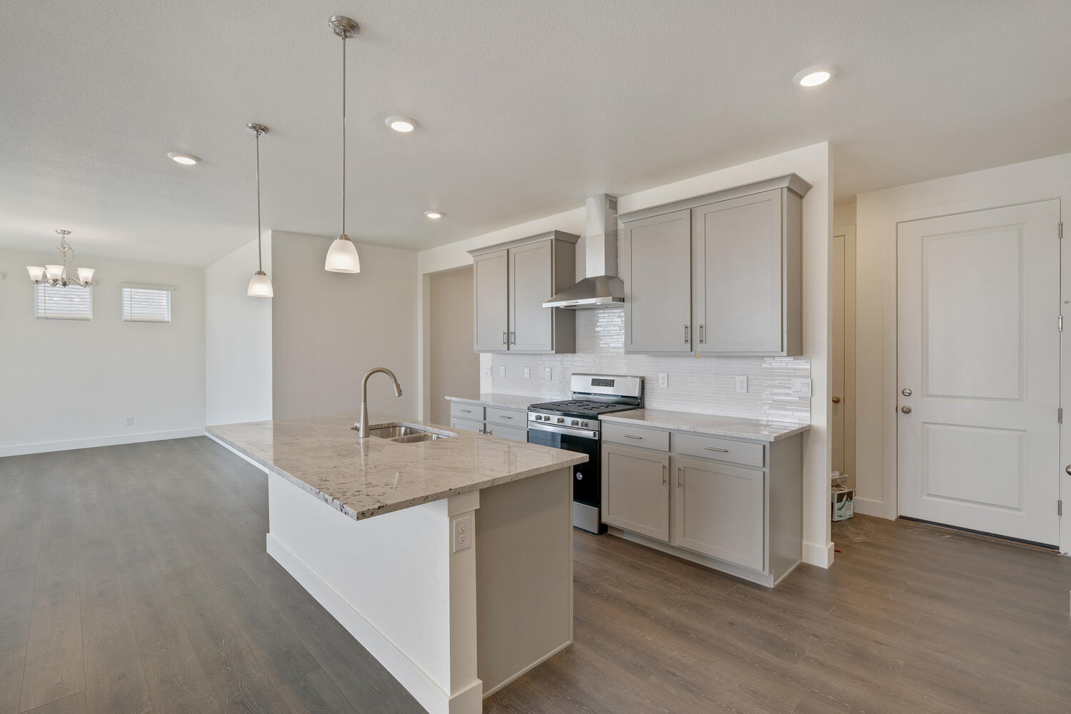 gray cabinet kitchen with an island and stainless steel appliances