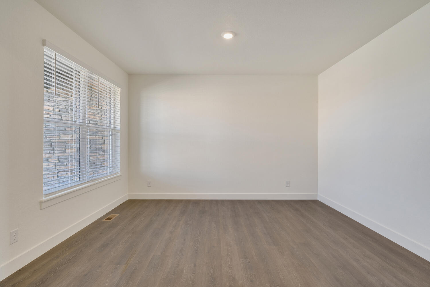 bedroom with a window and wood floor