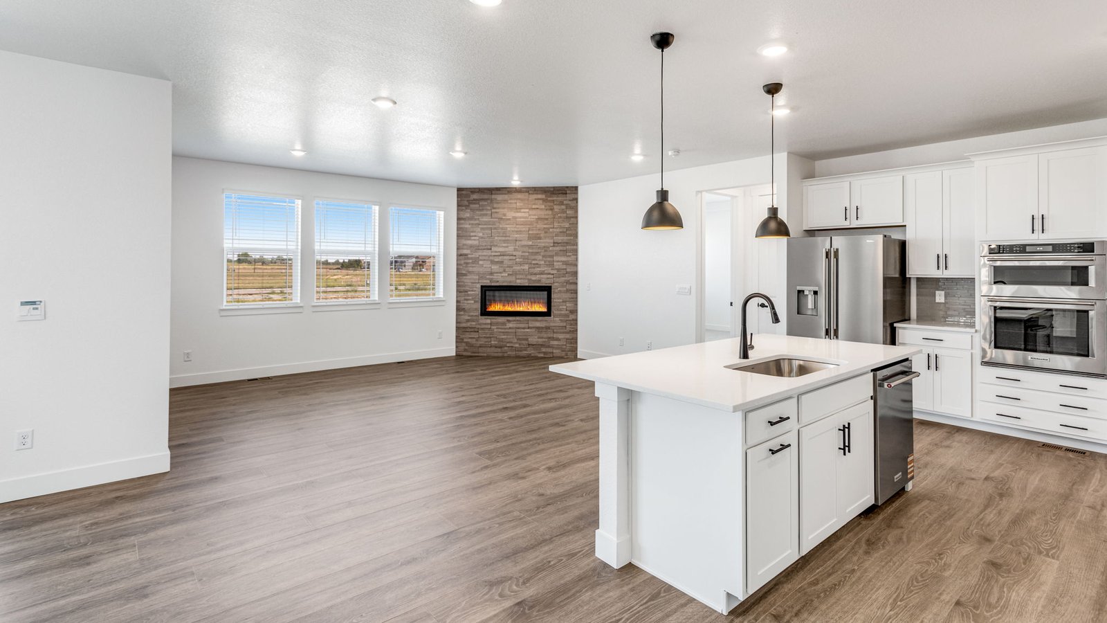 Open-concept kitchen in the Grover home with a gas range, crown-molded cabinets, and seamless flow to the dining area.