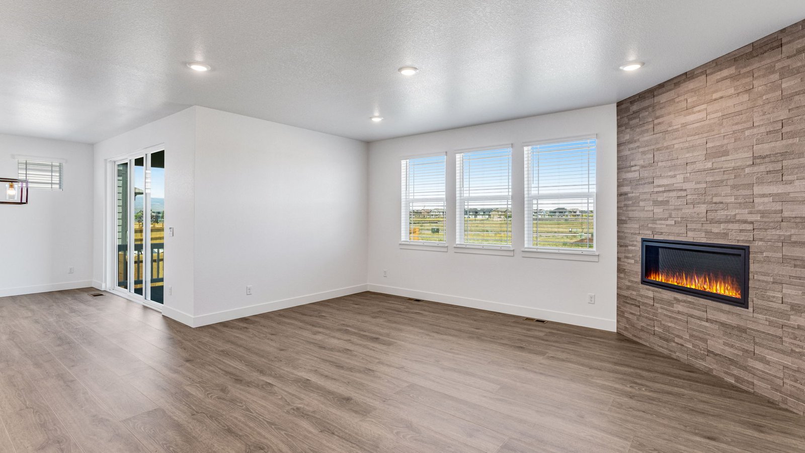 Open living area in the Grover floor plan connecting the kitchen, dining, and great room for effortless flow.