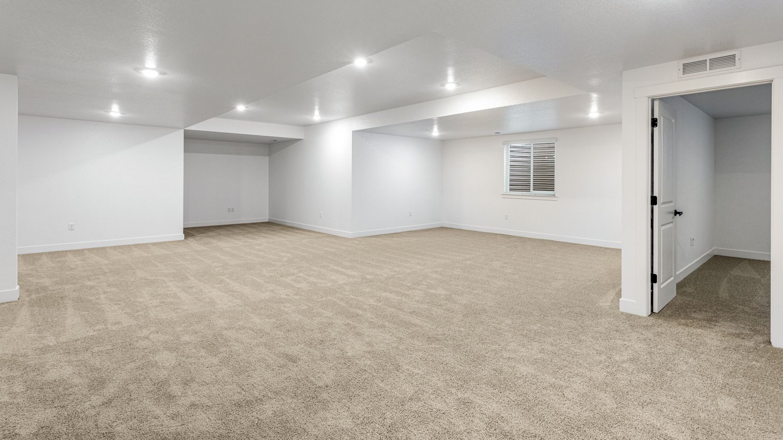 Spacious basement area in the Grover home providing additional storage and flexible living potential.