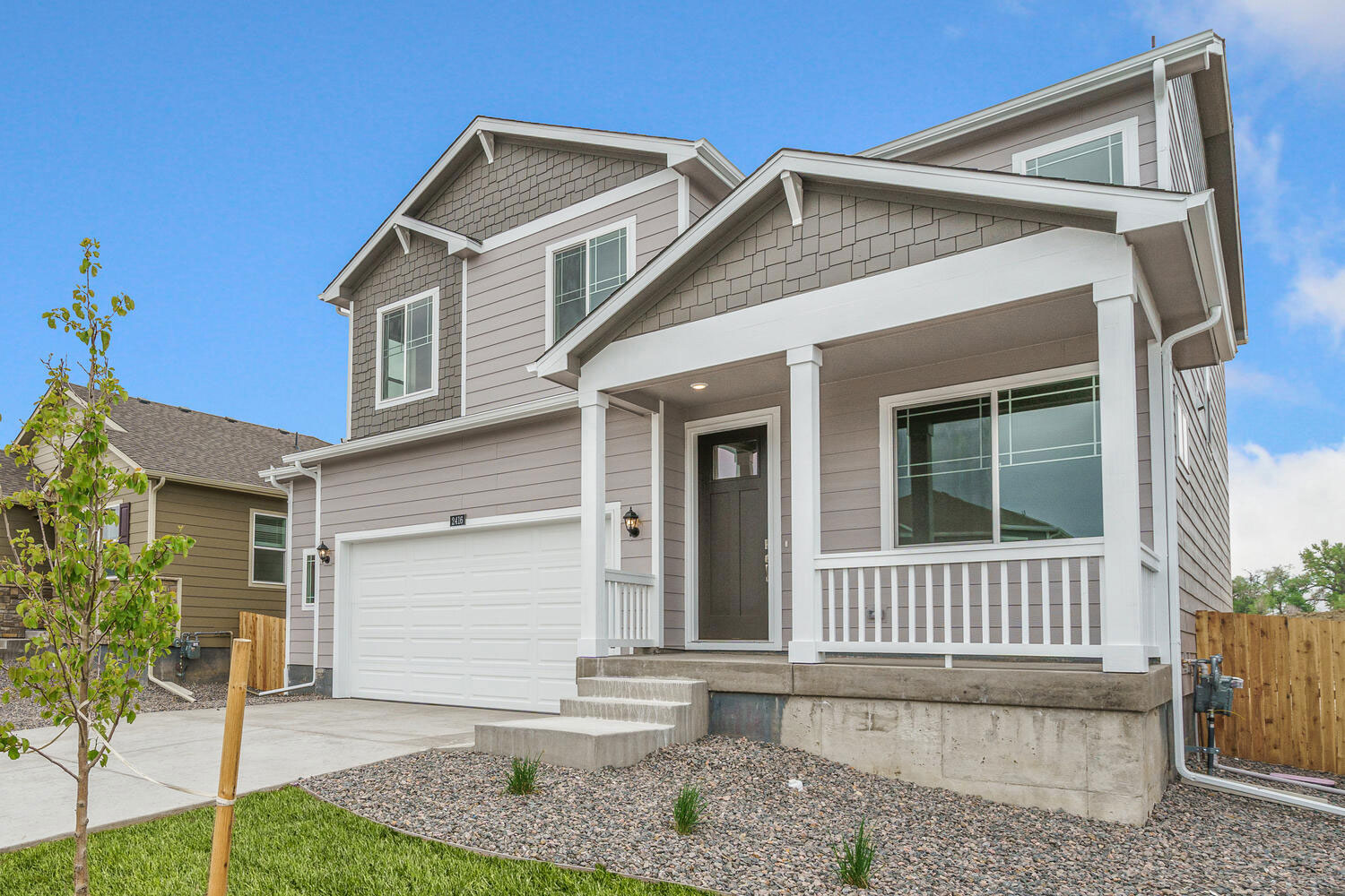 exterior photo of bellamy floorplan with two and half car garage with front yard landscaping