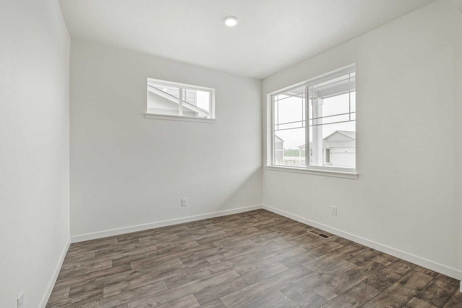 study with two windows and wood floor