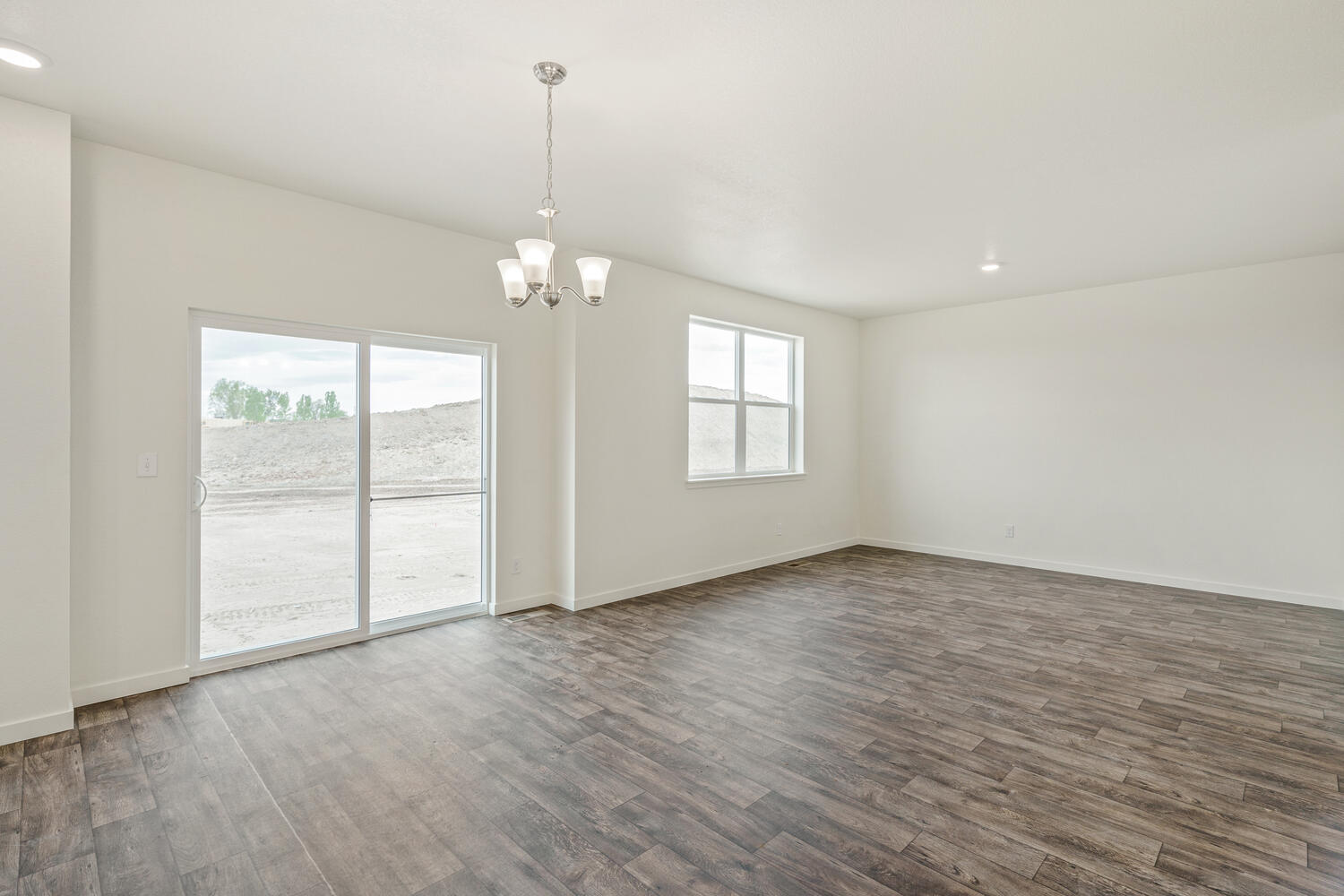 living room and dining room with a window, back door and ceiling light