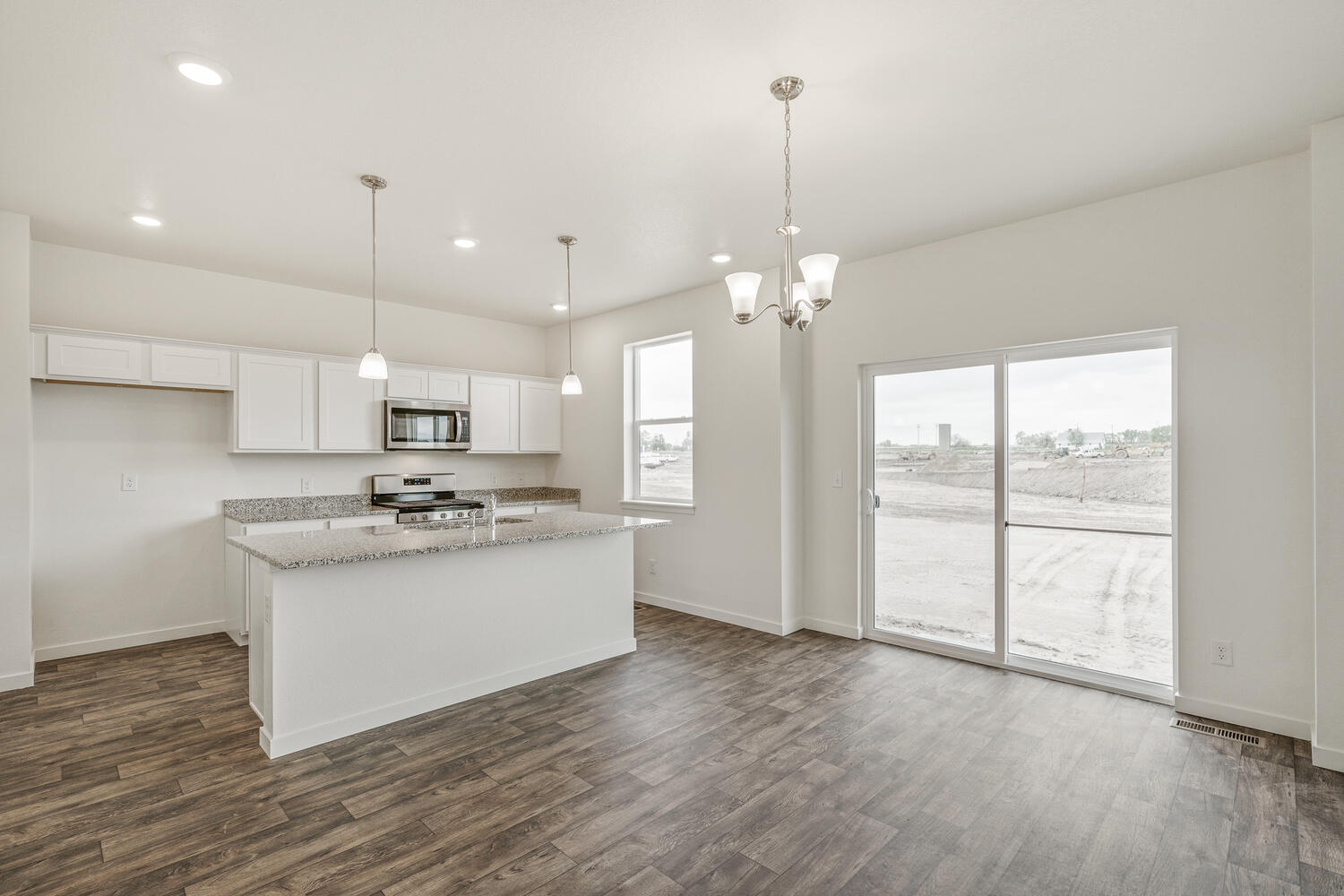 white cabinet kitchen with stainless steel appliances, a window, and back door