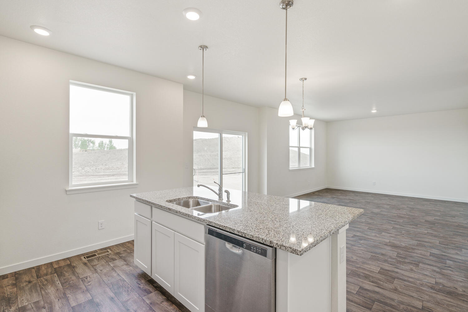 kitchen view of living room with a window, back door and wood floor