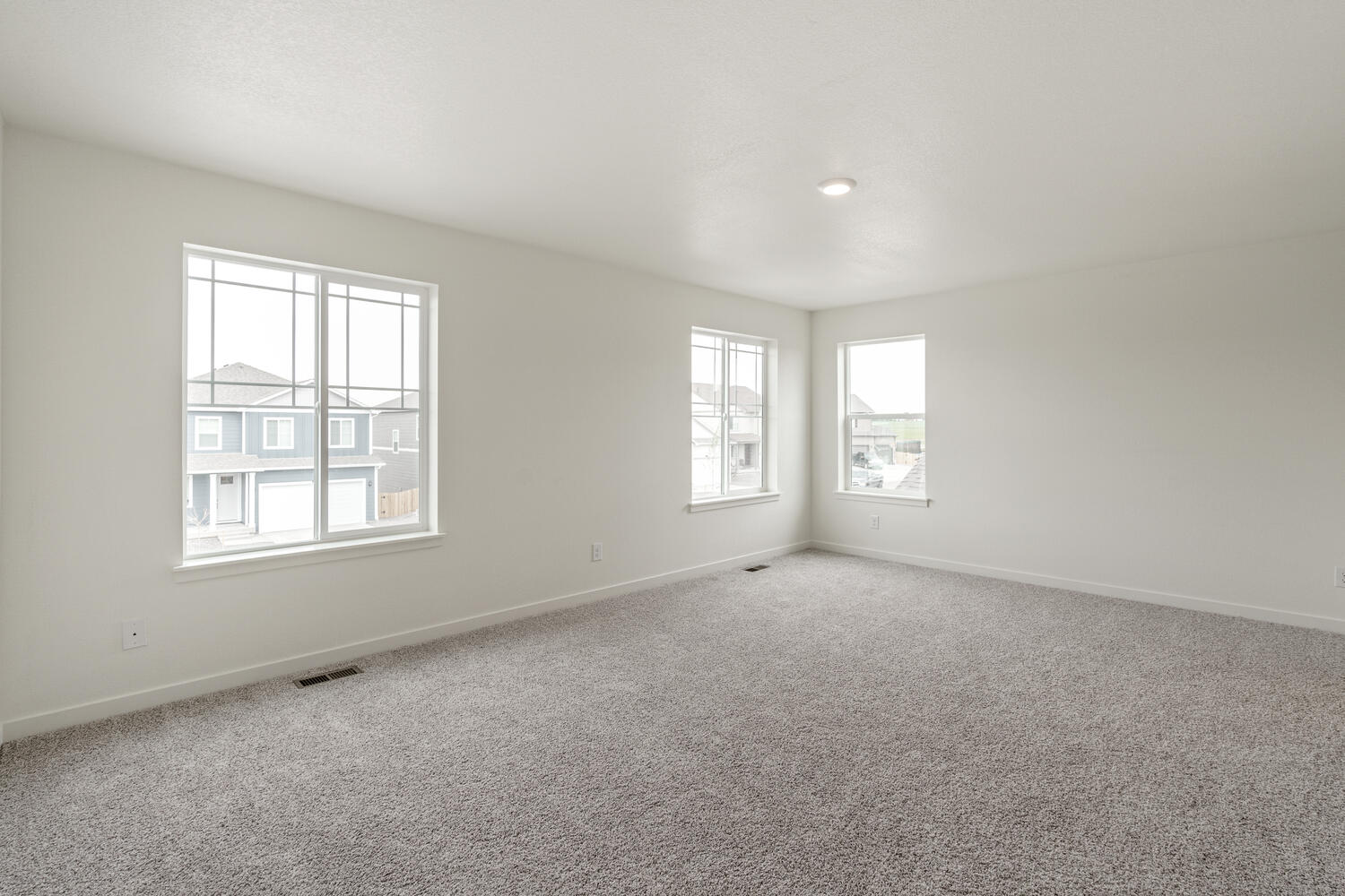 bedroom with two windows and carpet floor