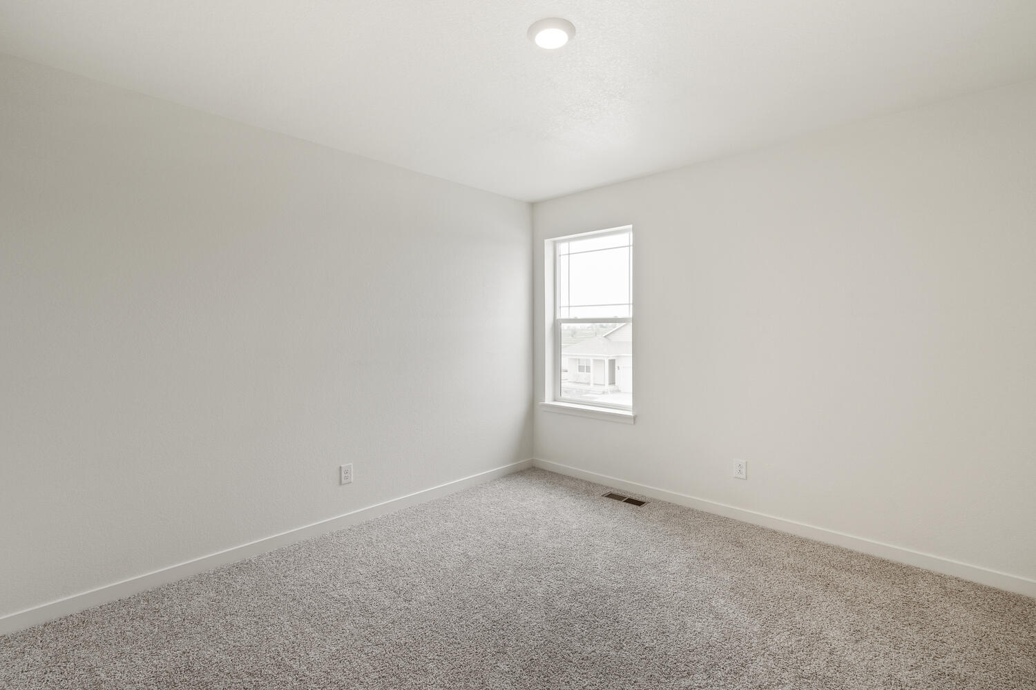 bedroom with a window and carpet