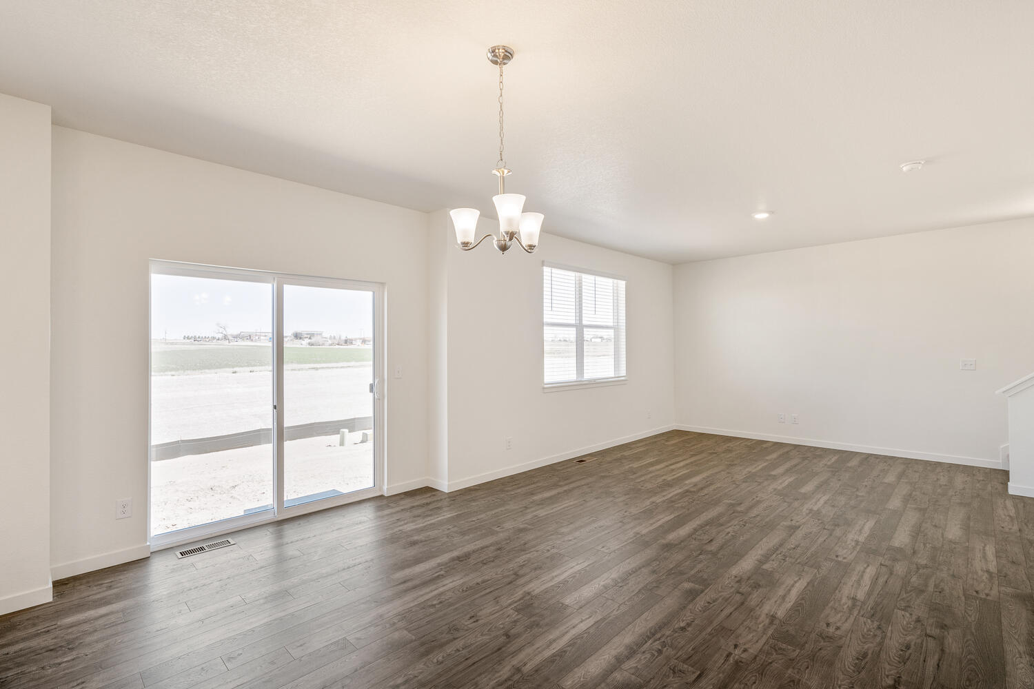 dining room with a back door, window and ceiling light