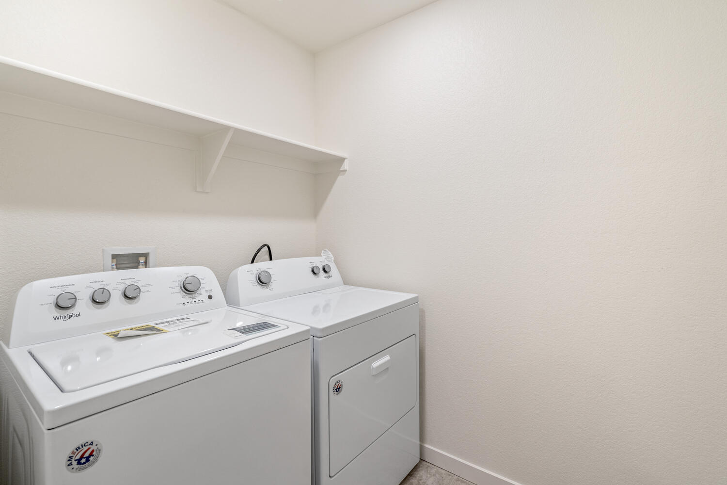 laundry room with a washer, dryer and shelves