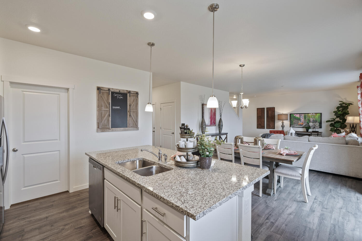 white gray cabinet kitchen with ceiling lights, an island and stainless appliances