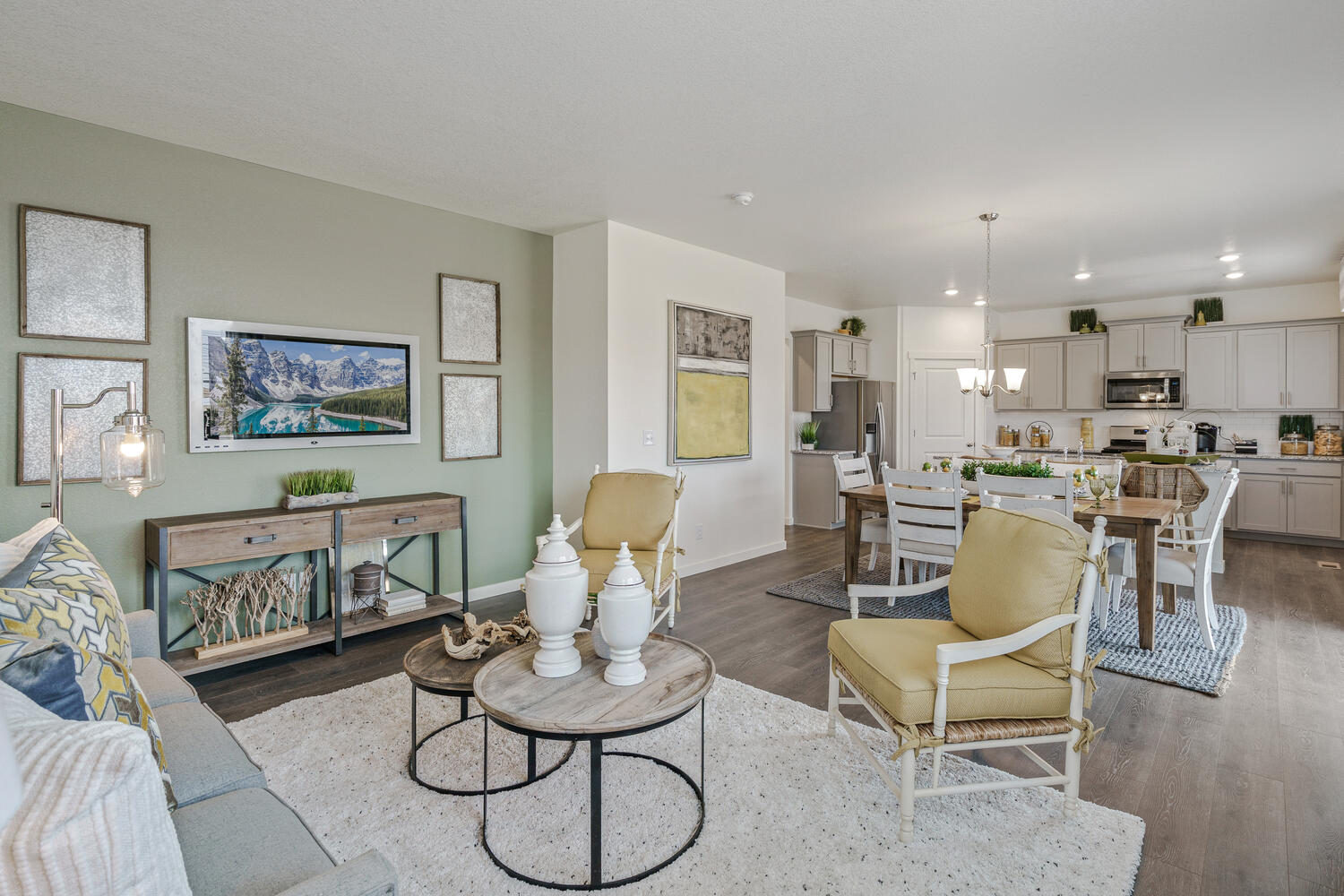 staged living room and kitchen with windows, and back door