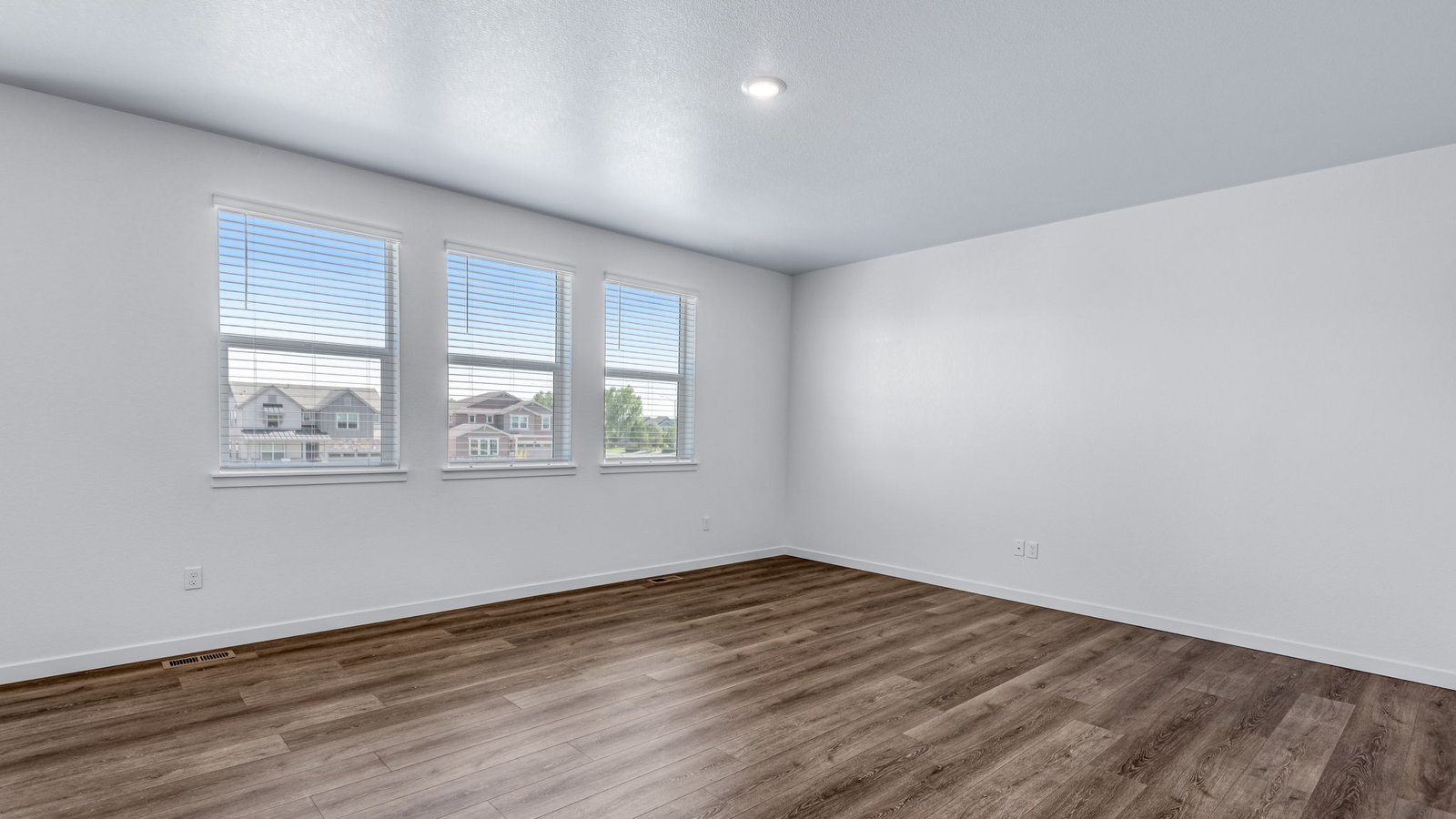 Open concept living room with natural light in new home in Brighton Colorado