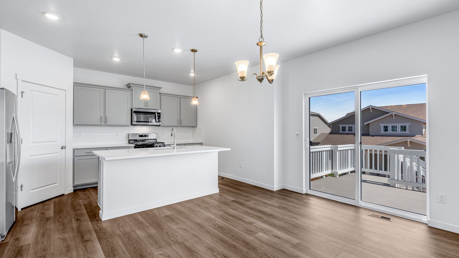 Kitchen with access to the backyard in new home in Brighton Colorado