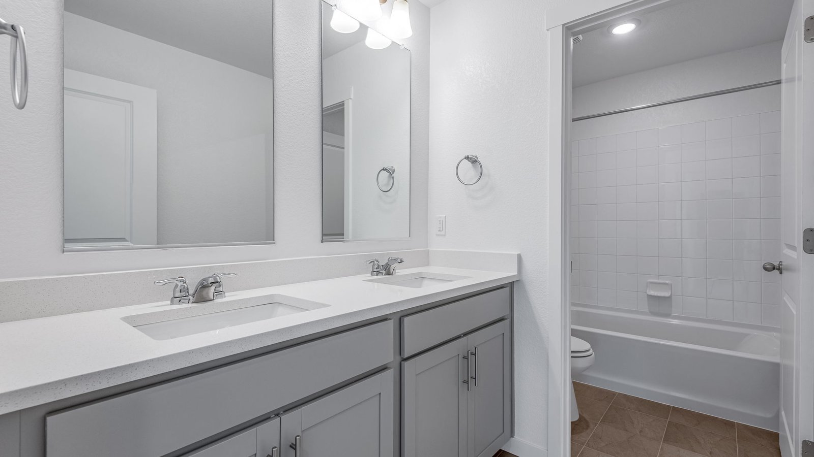 Secondary bathroom with dual vanity sinks in new home at Brighton Crossing