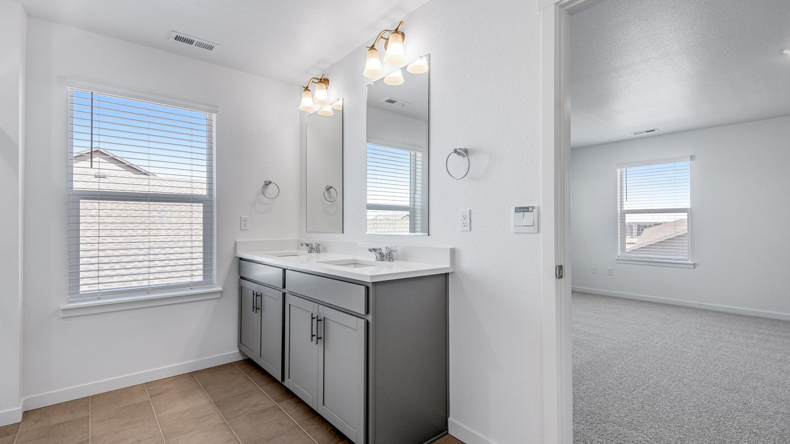 Attached primary bathroom in new home community Brighton Crossing