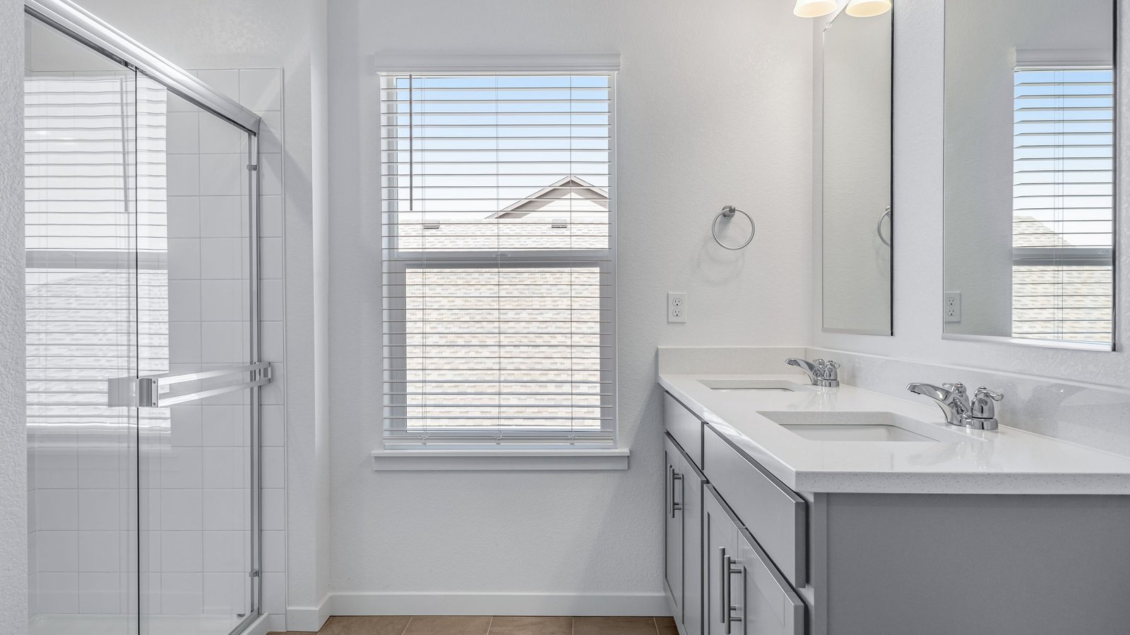 Attached primary bathroom in new home community Brighton Crossing