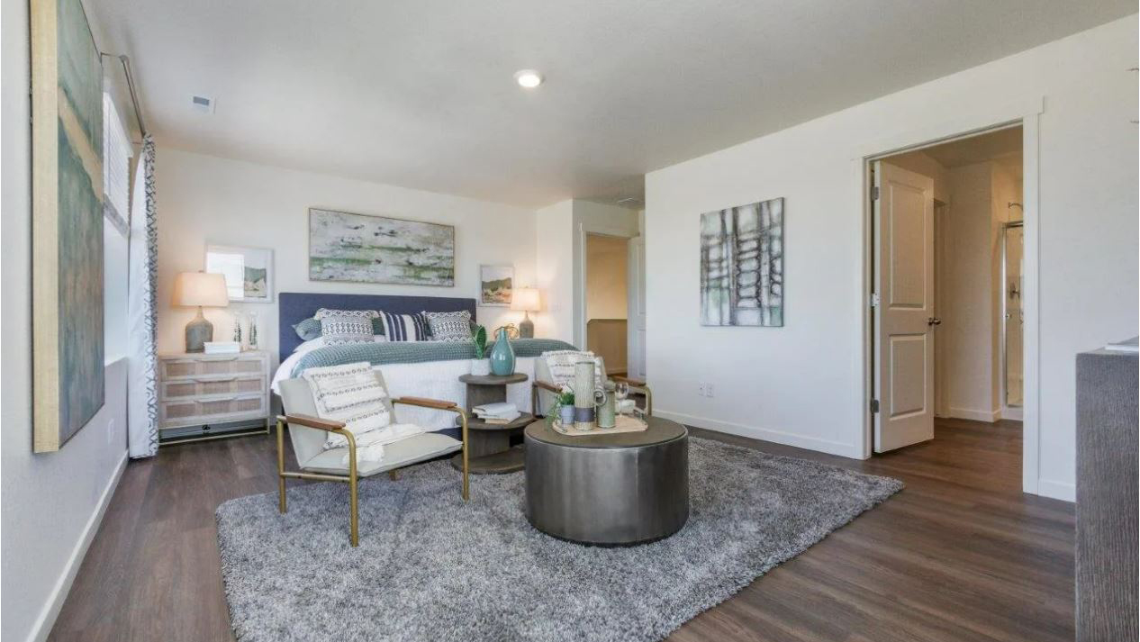 Spacious primary bedroom in new home at Brighton Crossing community in Brighton Colorado