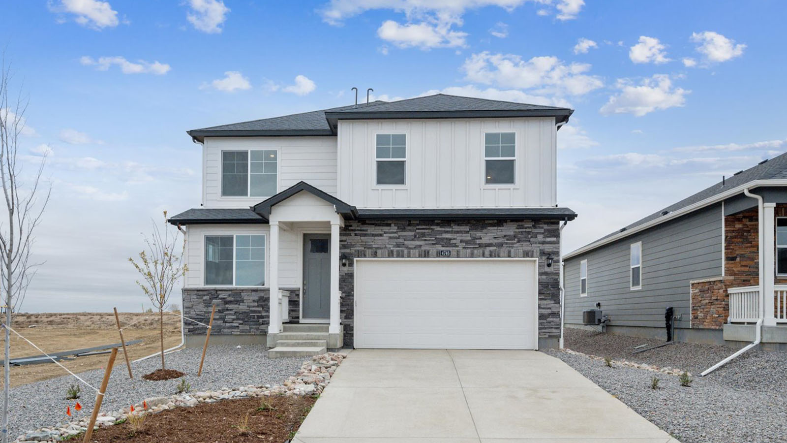 Exterior of two story home coming soon to Brighton Crossing Community in Brighton, Colorado