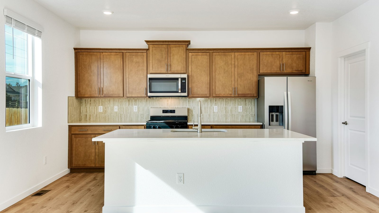 Spacious kitchen with new finishes in new home in Brighton Colorado