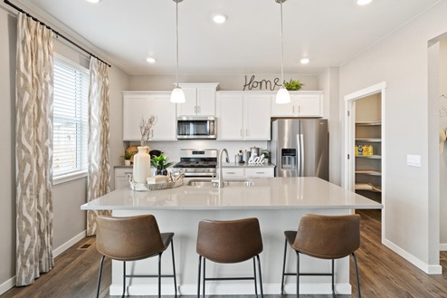 spacious kitchen with eat-in island and barstools