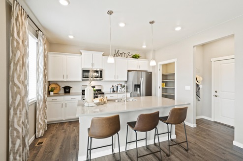 spacious kitchen with eat-in island and barstools
