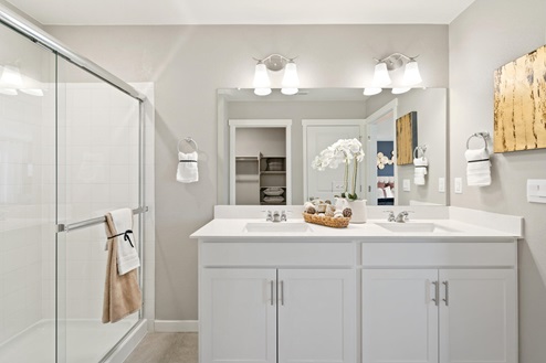 double vanity sink in bathroom with walk-in shower