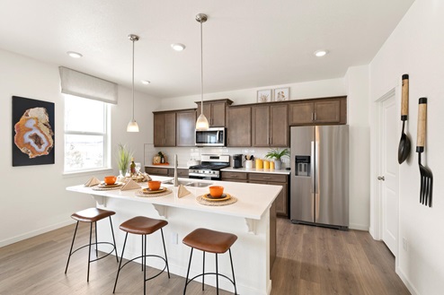 kitchen with stainless appliances, kitchen island with bar stools and premium cabinets