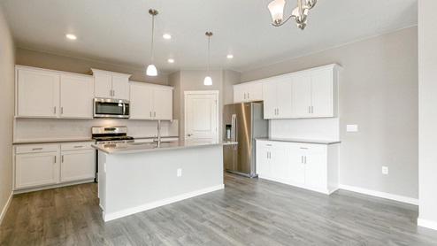 white cabinet kitchen with stainless steel appliances and an island