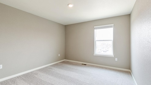 bedroom with a window and carpet floor
