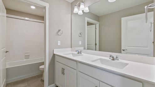 white cabinet bathroom with  a separate space for the toilet