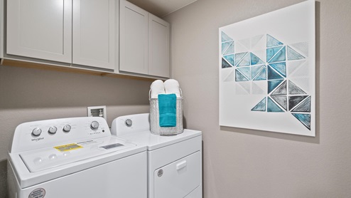 laundry room with washer, dryer and storage