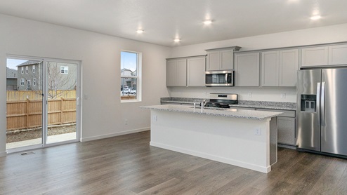 gray cabinet kitchen with an island, stainless steel appliances, a back door and a window