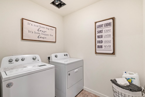 Walk-in Laundry room with full sized washer and dryer