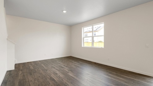 open space concept living room with dark wood flooring