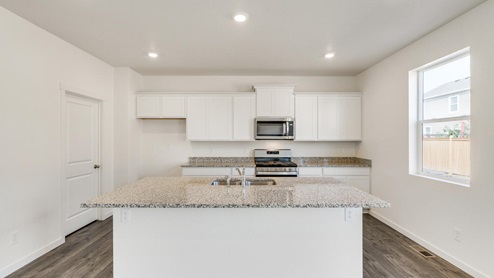 white cabinet kitchen with stainless steel appliances, and