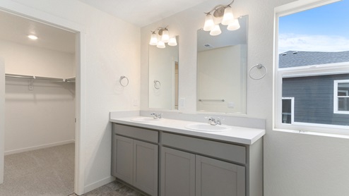 gray cabinet bathroom with a window