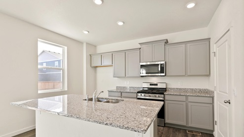 light gray cabinet in kitchen with a window