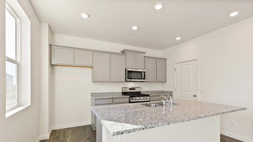 light gray cabinet in kitchen with a window