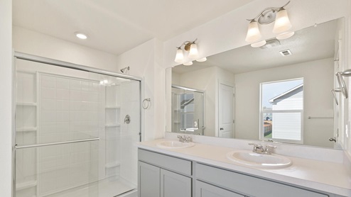 light gray cabinet bathroom with a shower