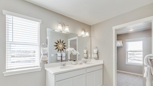 white cabinet bathroom with a window