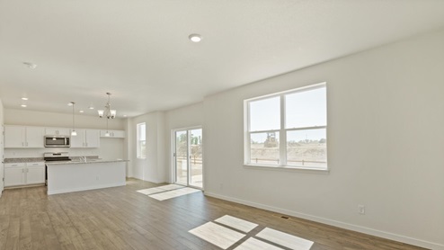 open space with kitchen, living room and window