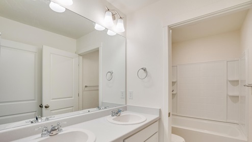 white cabinet bathroom with tub
