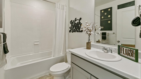 staged bathroom with a tub and sink
