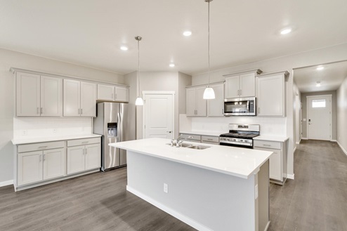 light gray cabinet kitchen with an island and stainless steel appliances