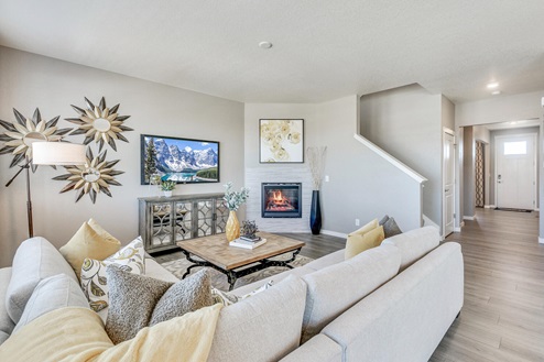 great room with sectional couch, entertainment stand and fire place